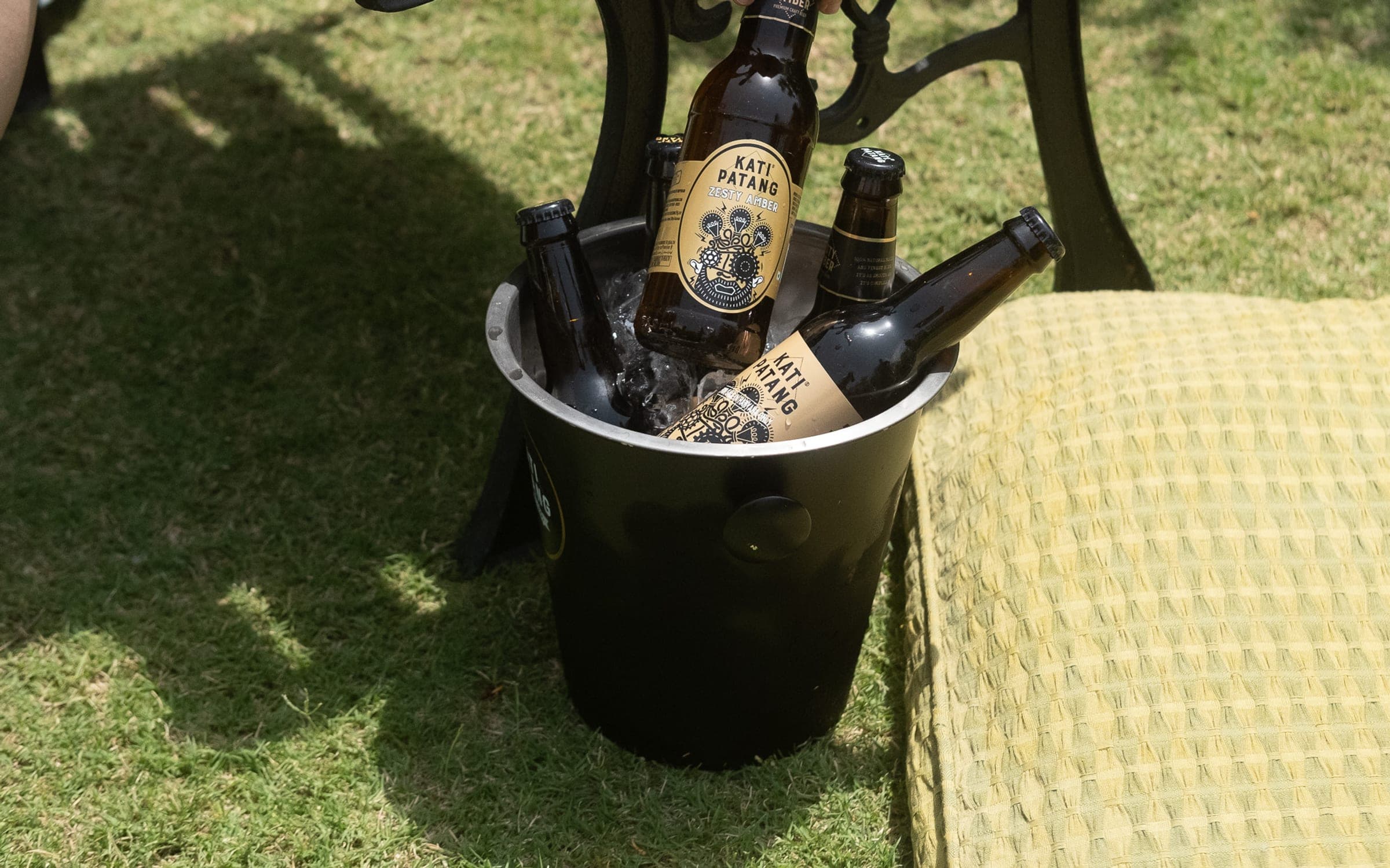Kati Patang bottles chilling in an ice bucket on a lawn