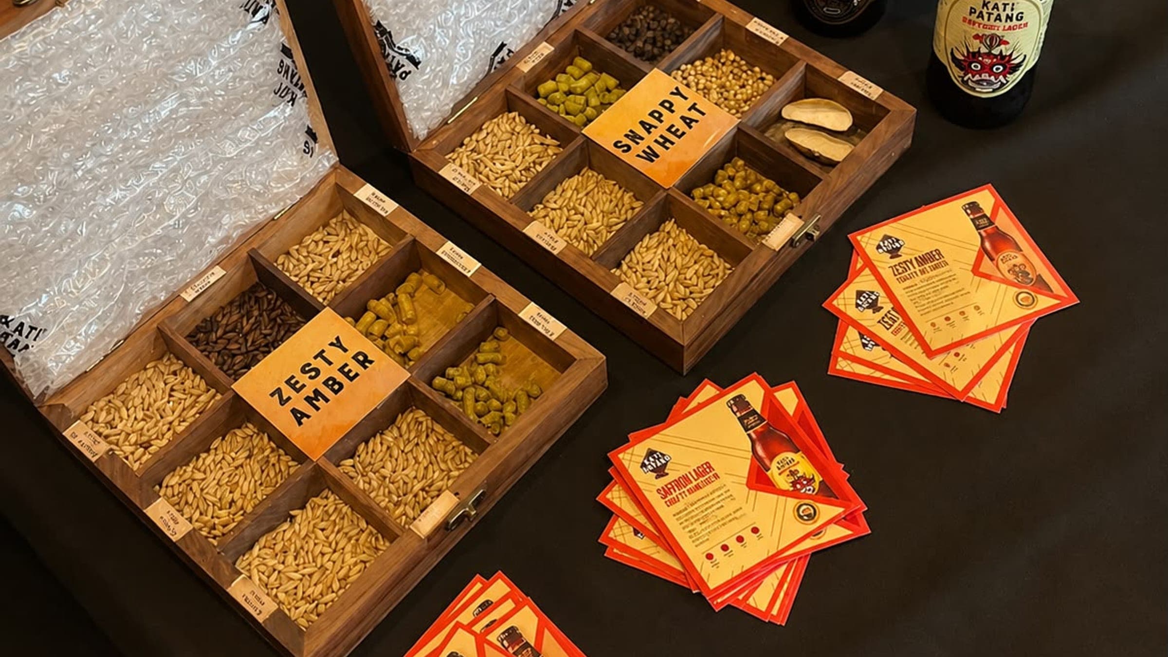 Wooden ingredient boxes displaying the malts and hops used in each Kati Patang beer