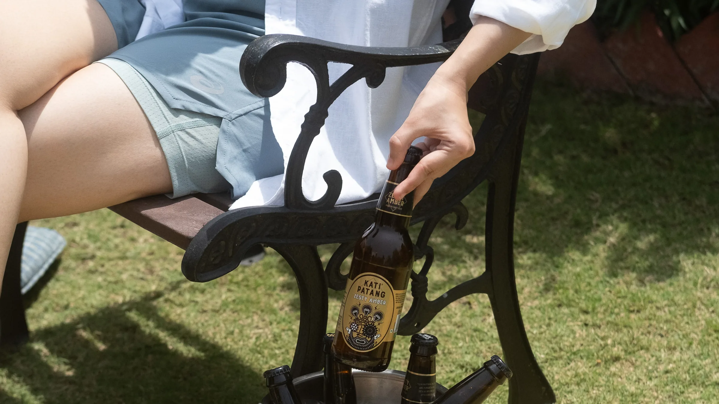 Kati Patang Zesty Amber bottle being lifted from an ice bucket